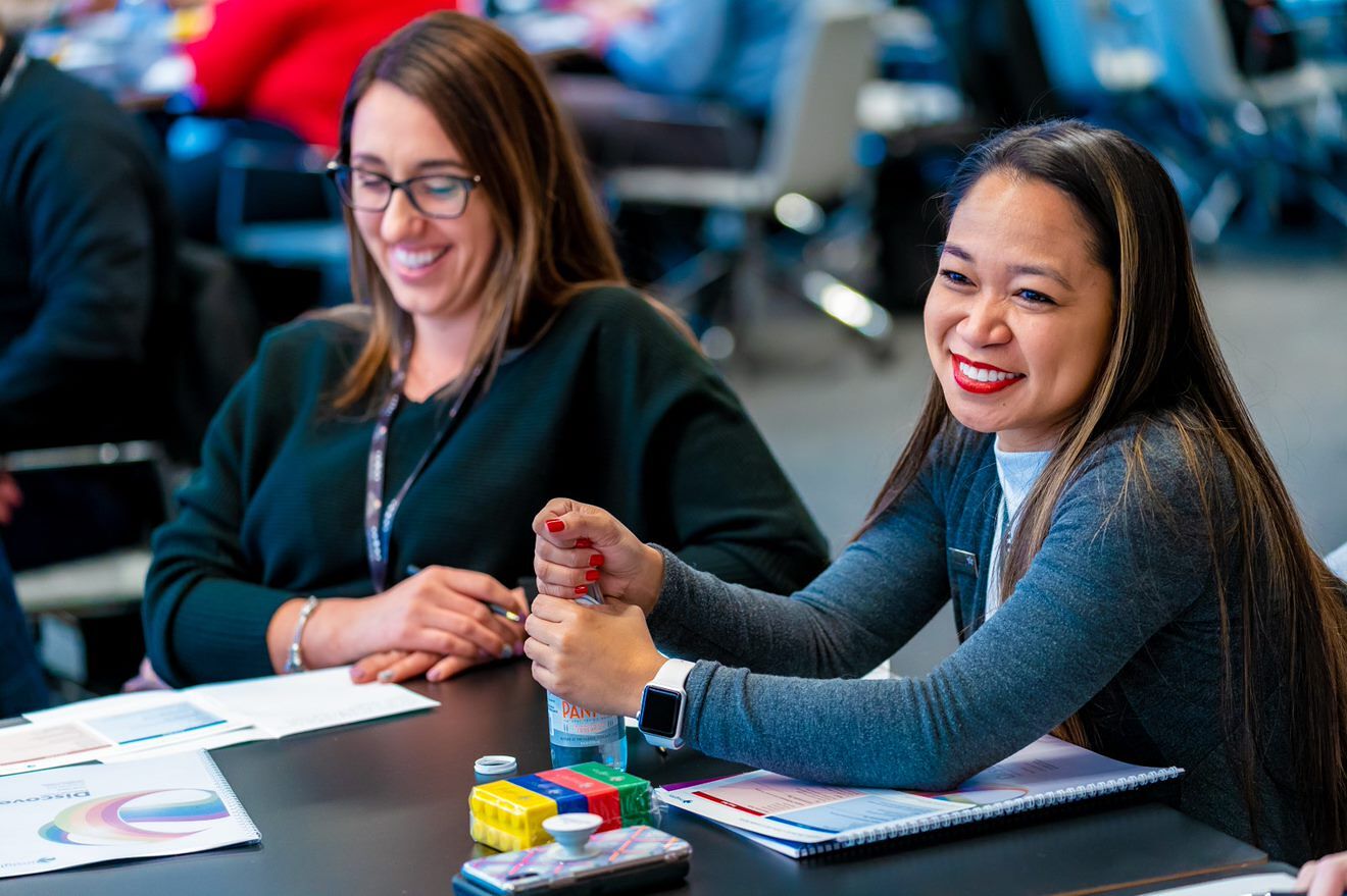 2 females at table smiling